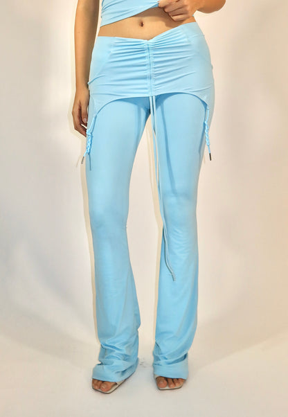 Light blue pants worn by a person on a plain background
